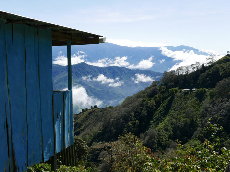 A blue house perched on the side of a mountain pass in Costa Rica Behind the Scenes of Order to Kill