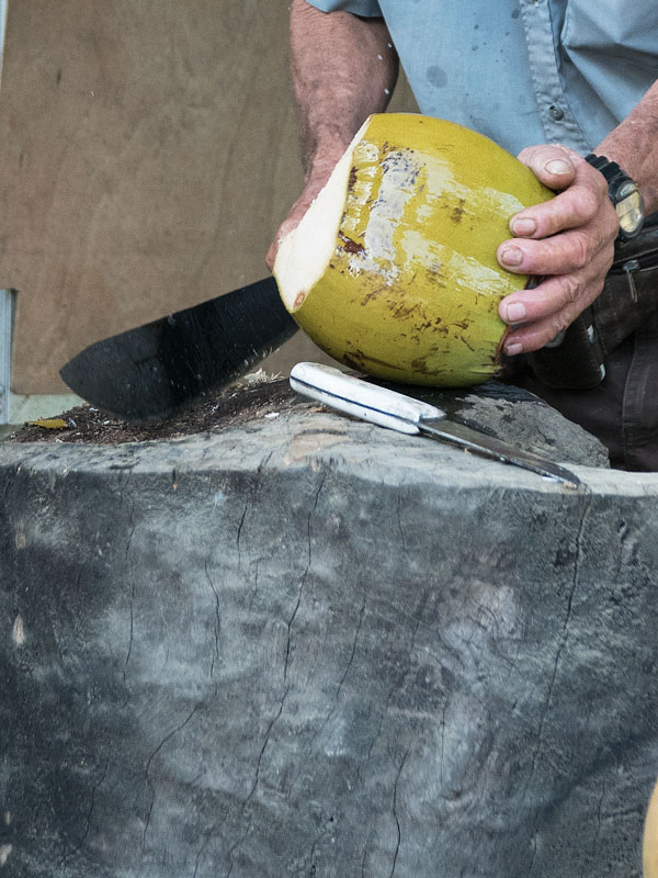 A vendor opens a coconut with a machete Behind the Scenes of Order to Kill
